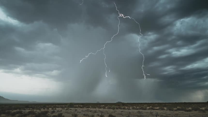 Lightening arcs across the sky over a large flat plain