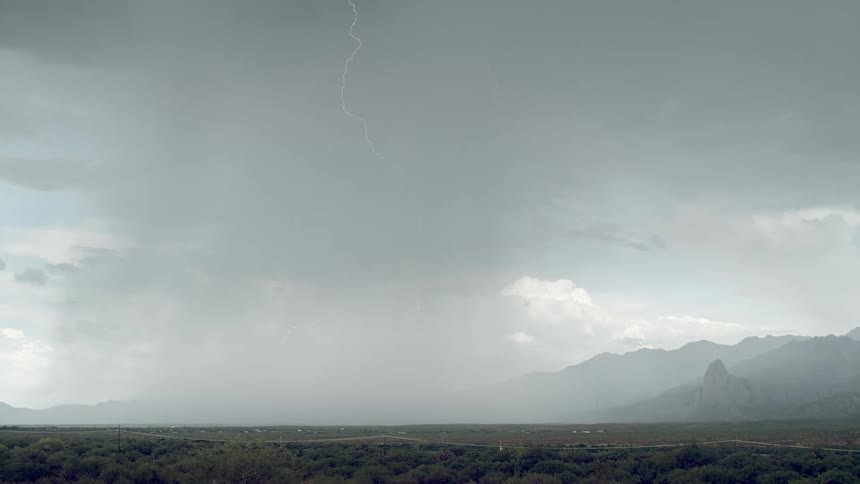 Multiple bolts of lightning strike the ground during a thunderstorm