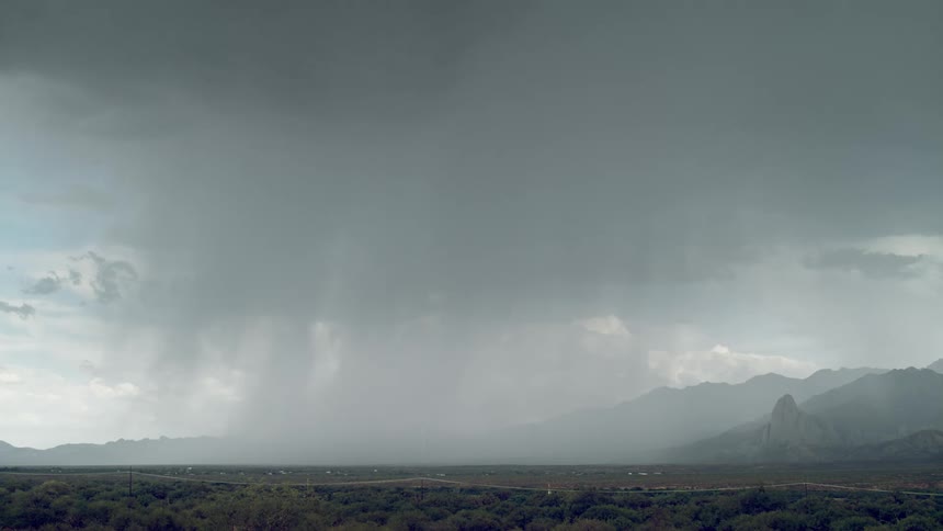 Landscape with mountains and trees on a day with storm and lightning