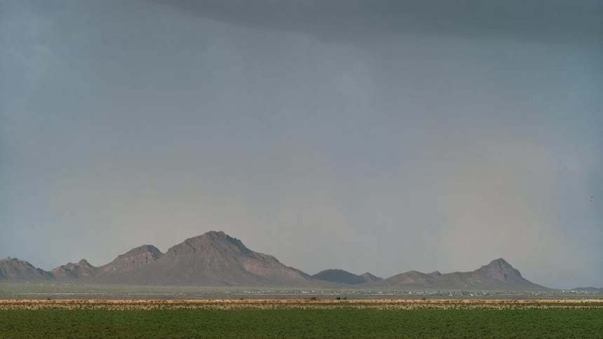Lightning from a storm lights up the sky over a mountain range