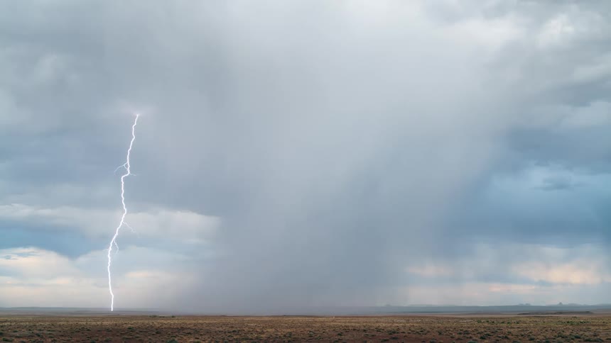 A lightning storm in a flat environment with light clouds in the sky