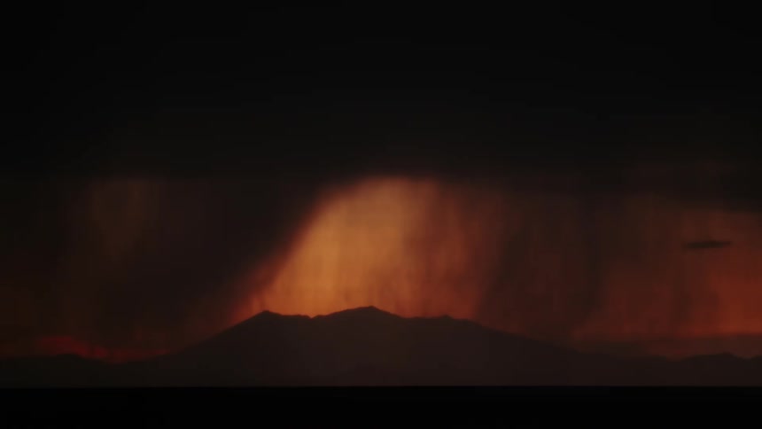 A dramatic scene of several lightning strikes against a dark cloudy sky above silhouetted mountains