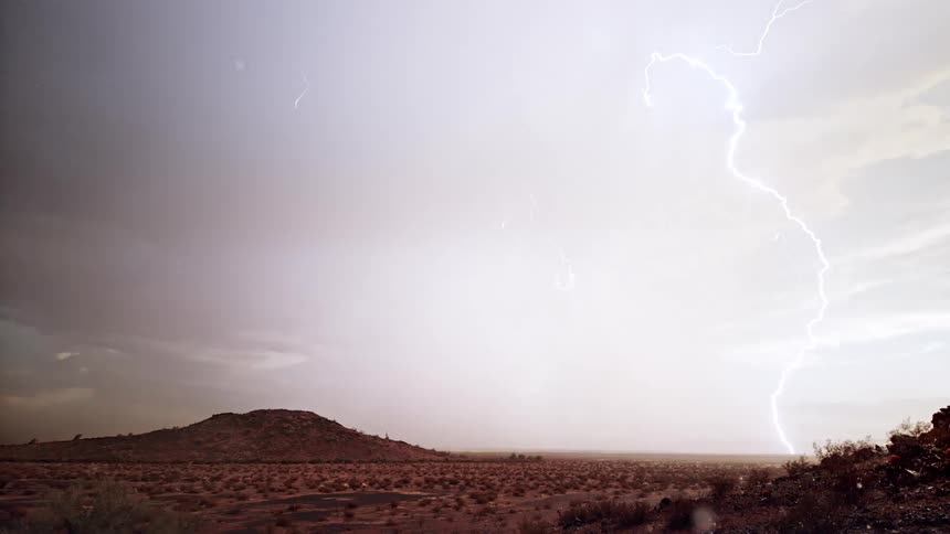 Arid landscape with mountains on a rainy day with gusts of thunder