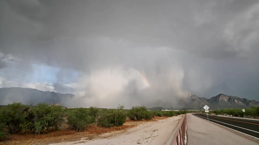 Landscape with a highway and storm above mountains with thunder