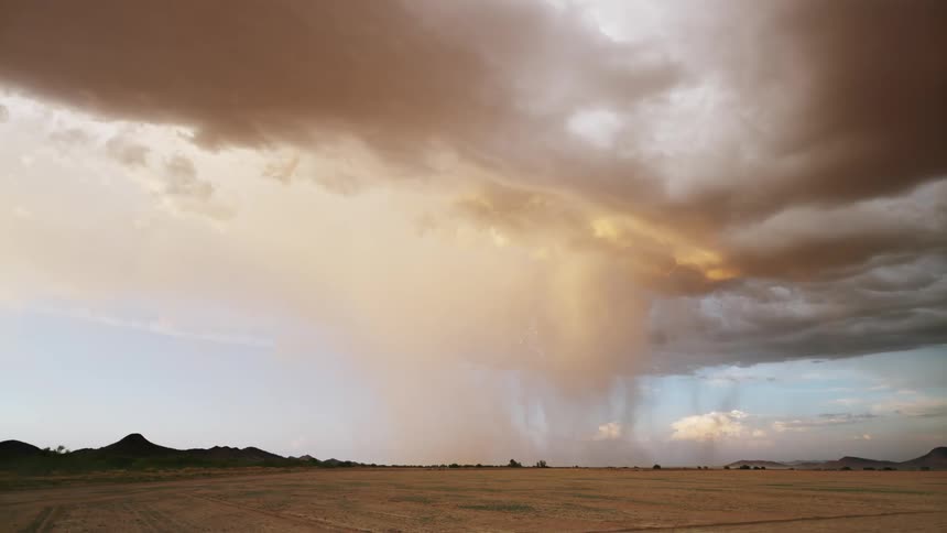 Dense storm with lightning above a field