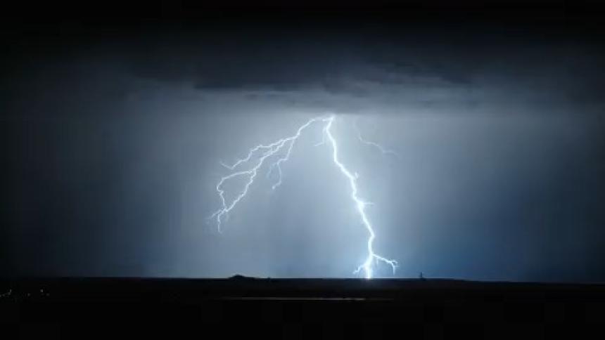 Bright thunder lighting up a dark sky