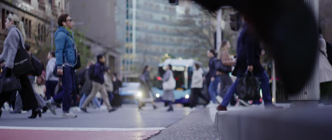 Pedestrians in a metropolis walking and crossing the street