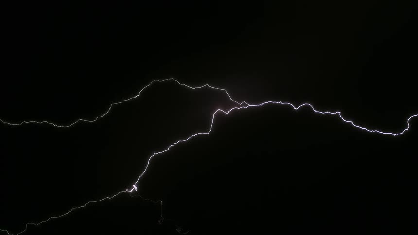 A strong bright ray tearing through the dark sky