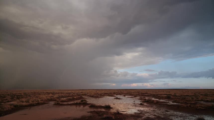 Storm with lightning above a field with water