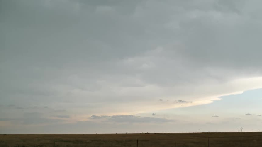 A bright ray falling from the sky in a flat horizon and white sky environment