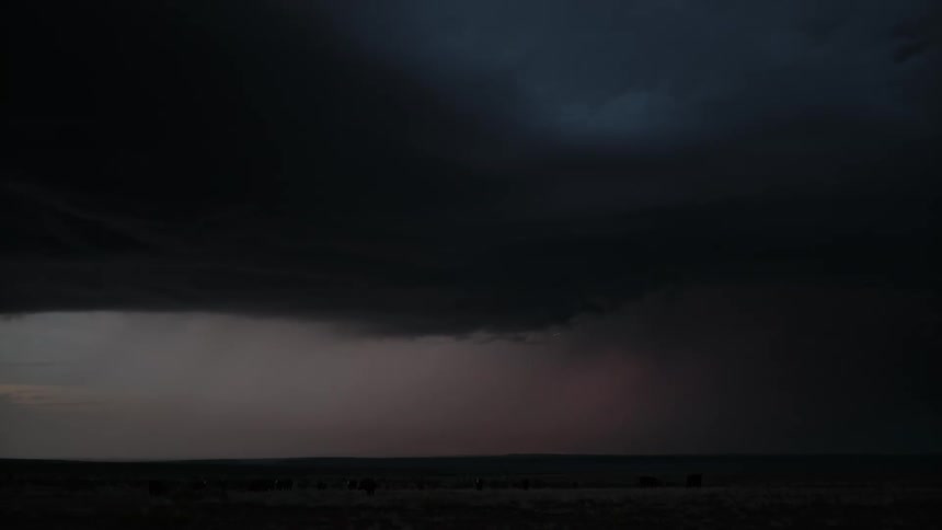 Lightning moves through the dark clouds of a thunderstorm over the plains