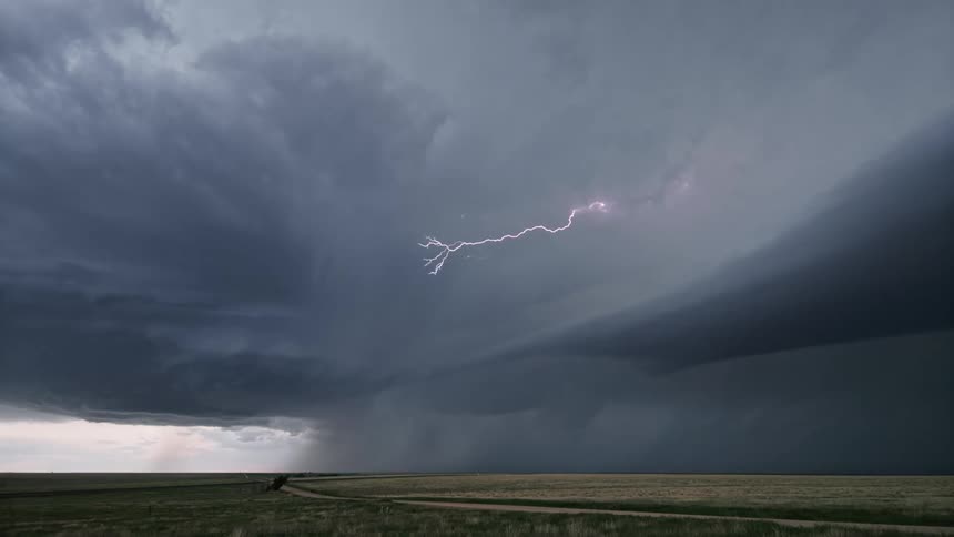 Scenery of a field and a dark sky with storm and lightning