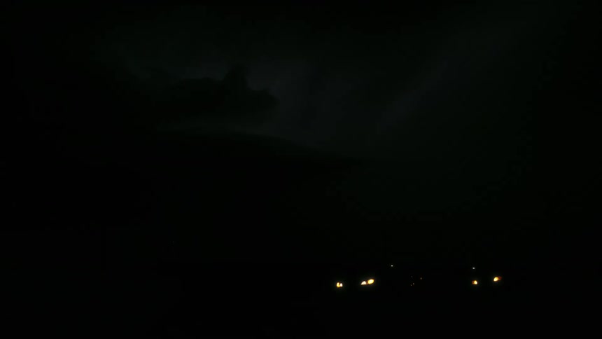 A storm of bright rays lighting up a sky on a dark night