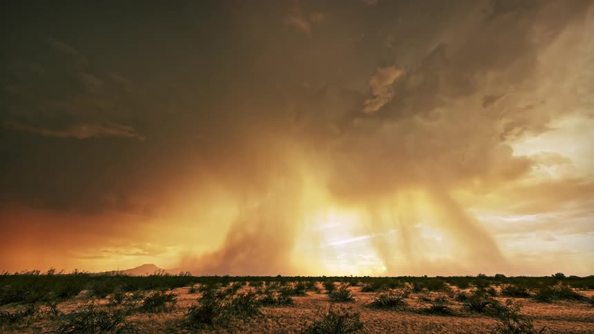 Scenery of a field and a dark sky with storm rain and thunder