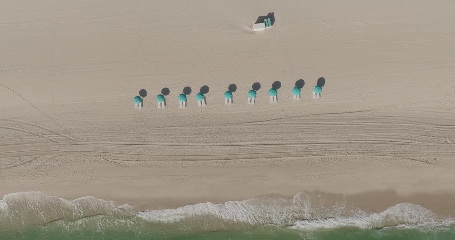Seats with umbrellas are on the beach