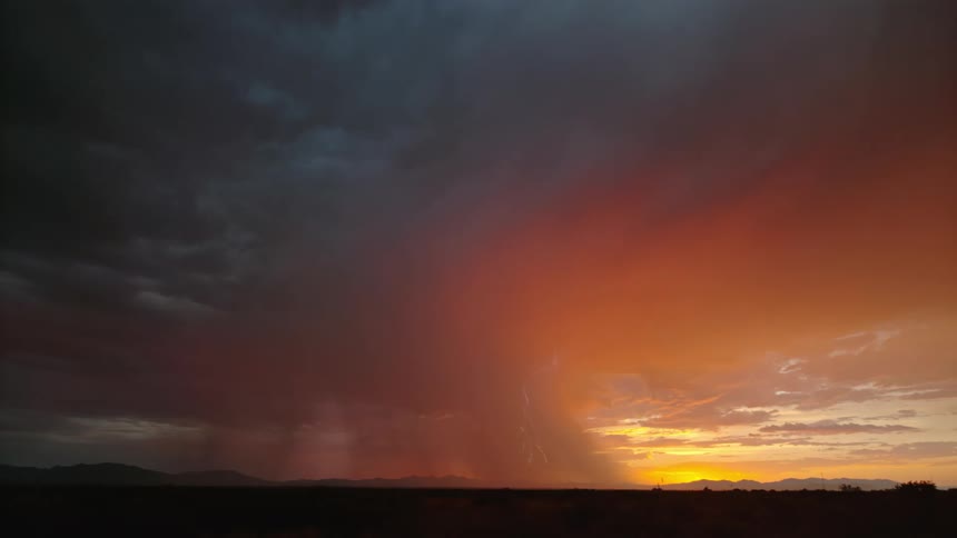 A lightning storm coming out of a sky that is orange in color