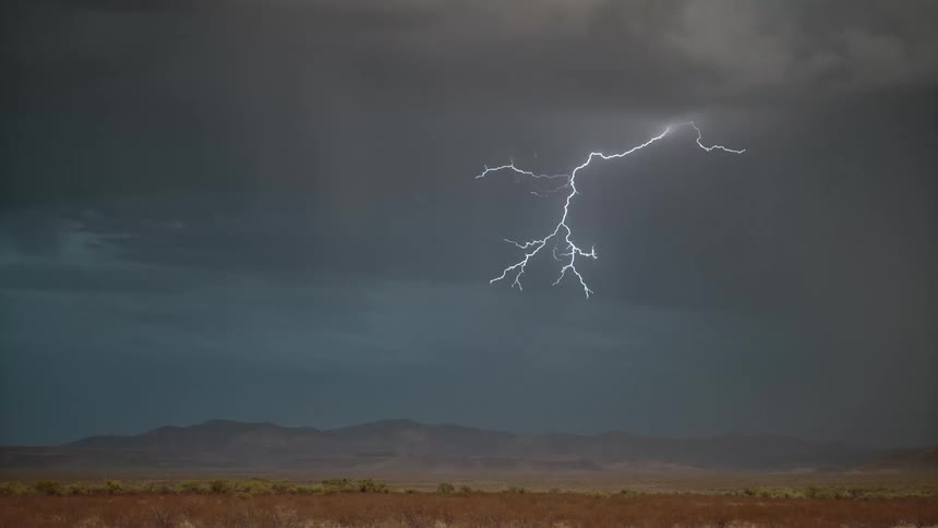 Landscape with silhouette of mountains and thunder in a cloudy storm