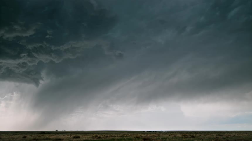 Storm with lightning above a greenish field