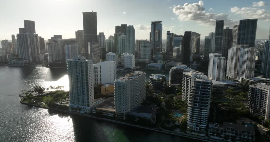 An aerial view of a city with several tall buildings facing the sea