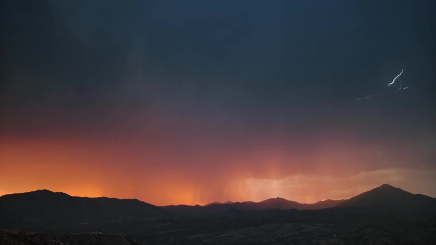 Scenery of a field and mountains and a red and dark sky with storm and thunder