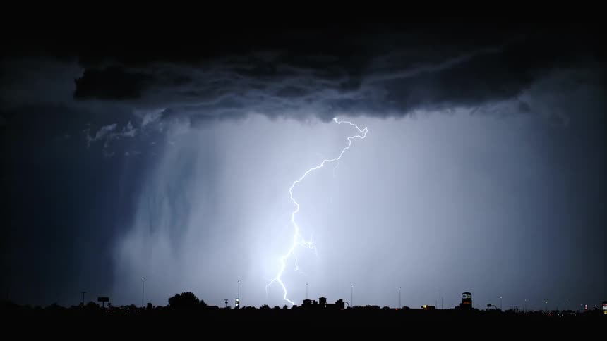 Thunderstorm at night above a metropolis