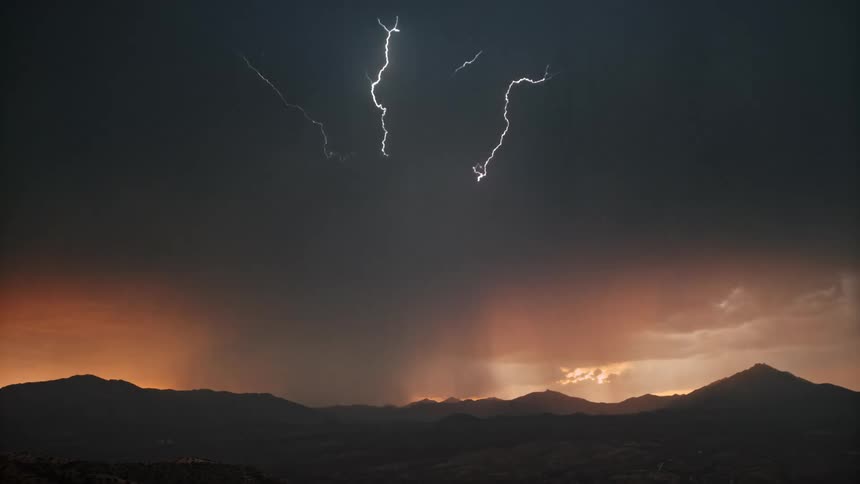 Landscape with silhouette of mountains in a sky with thunder