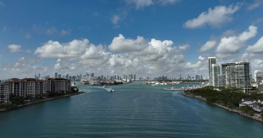 A boat travels through an ocean canal in a resort area