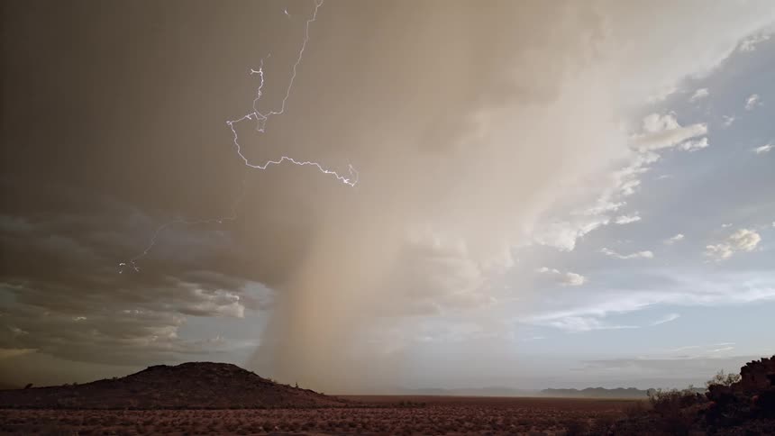 Streaks of lightning emerging from a thick gray cloud