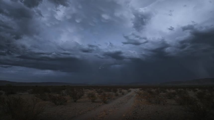 A dramatic scene of a lightning strike under a dark stormy sky in a vast desert landscape