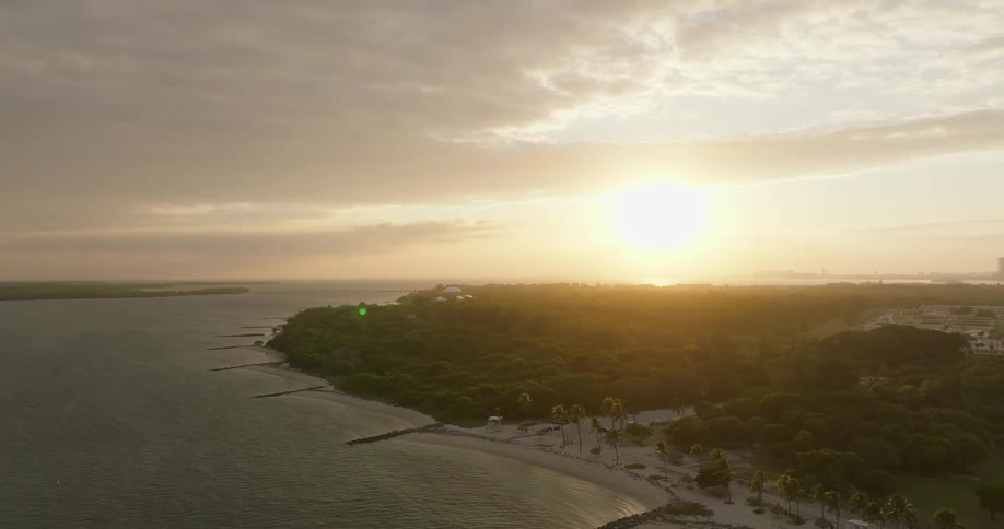 Sunrise over the horizon in a coastal area with beach