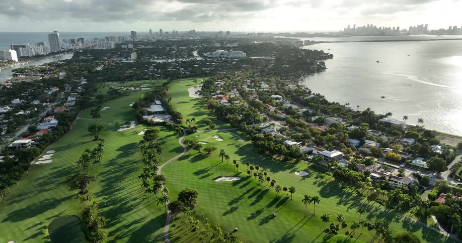 An aerial view of a coastal area with a golf course next to the ocean
