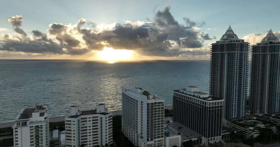 A coastal city skyline with high rise buildings and a serene ocean