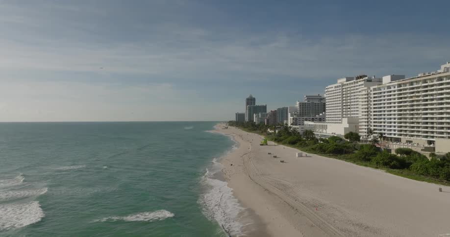 Beach with turquoise waters and buildings around