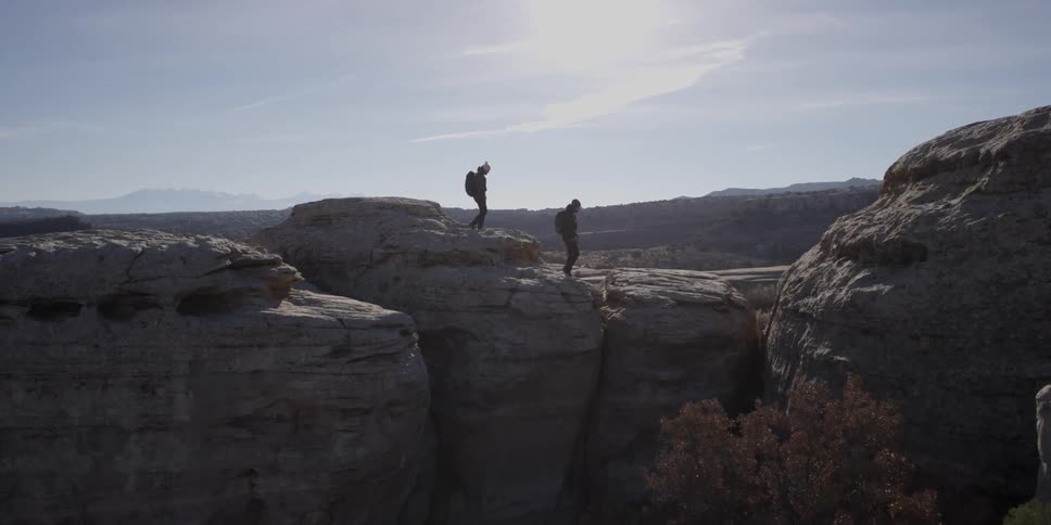 Two people are hiking on top of a mountain