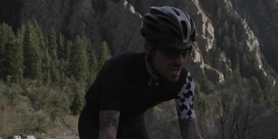 A man rides a bicycle up a hill