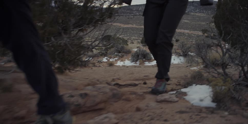 Two people hike along a ridge