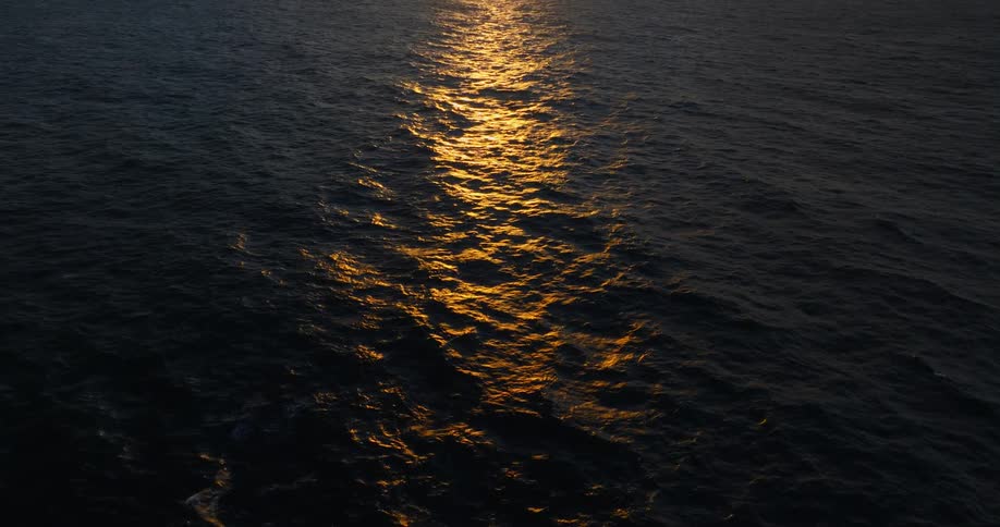 Calm waters of an ocean with a reflection of the sun