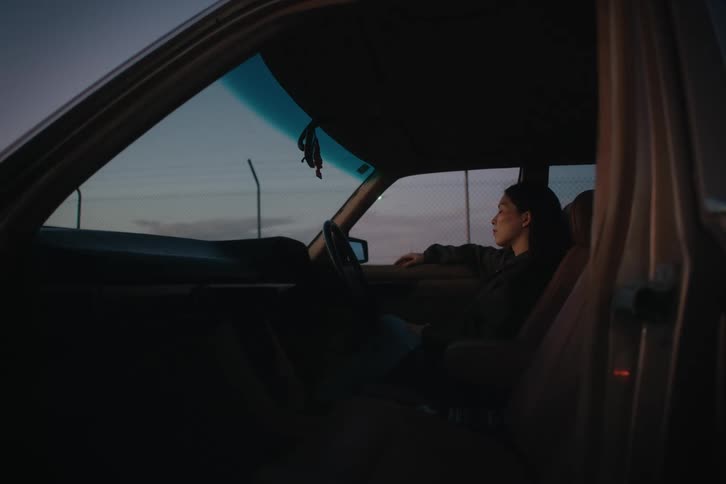 Woman sitting in the front seat of a car