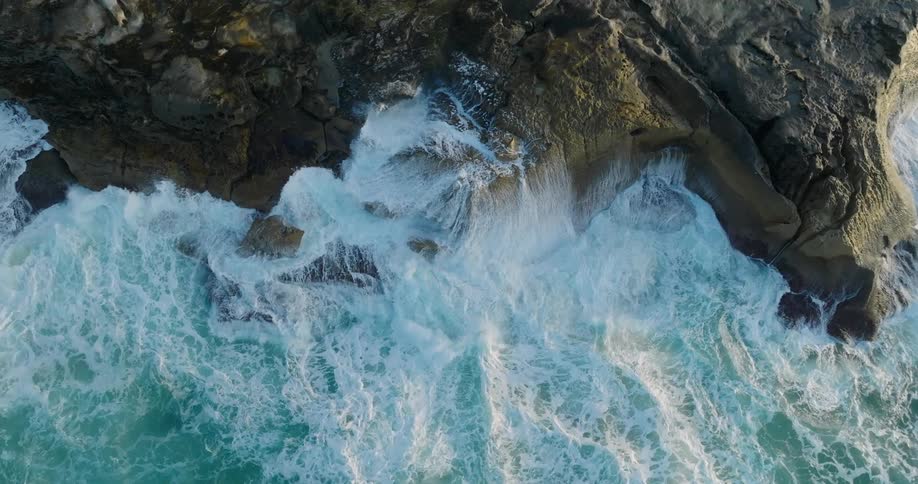 Huge waves crash against a rocky shoreline