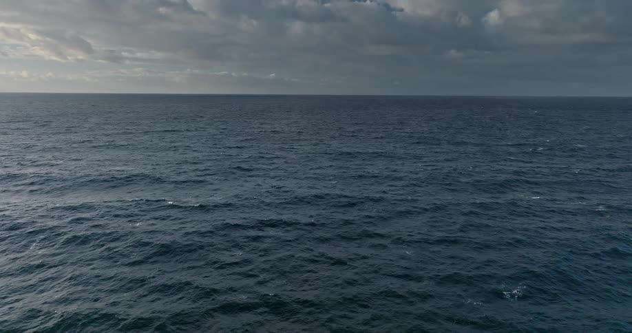 Panorama of an extensive blue ocean against the dubbed sky
