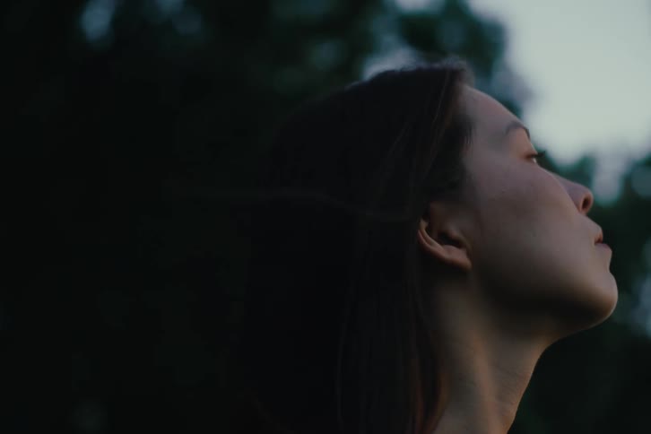Portrait of a woman outdoors looking up