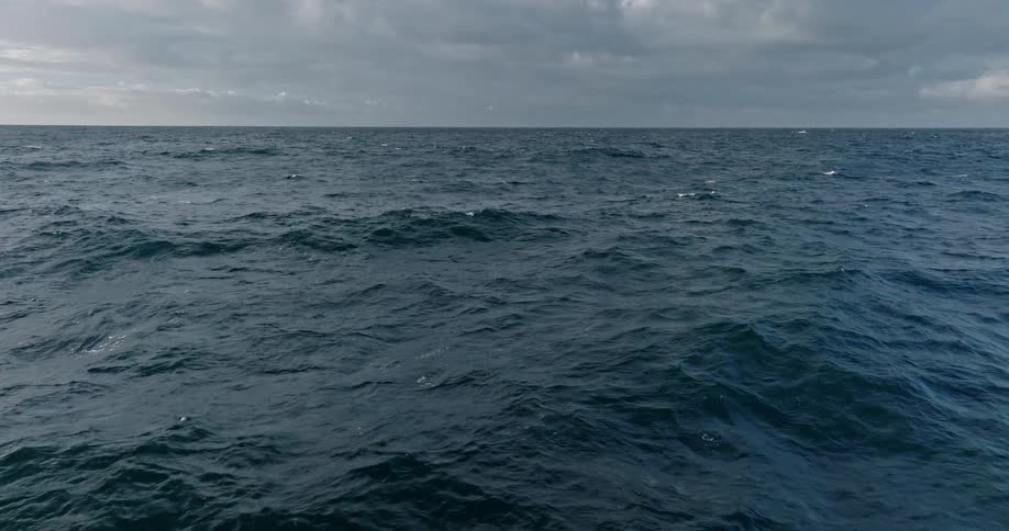 A blue ocean with some small ripples of waves on the surface