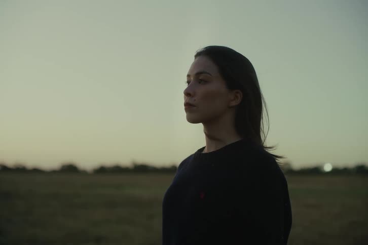 Woman in a natural field observing