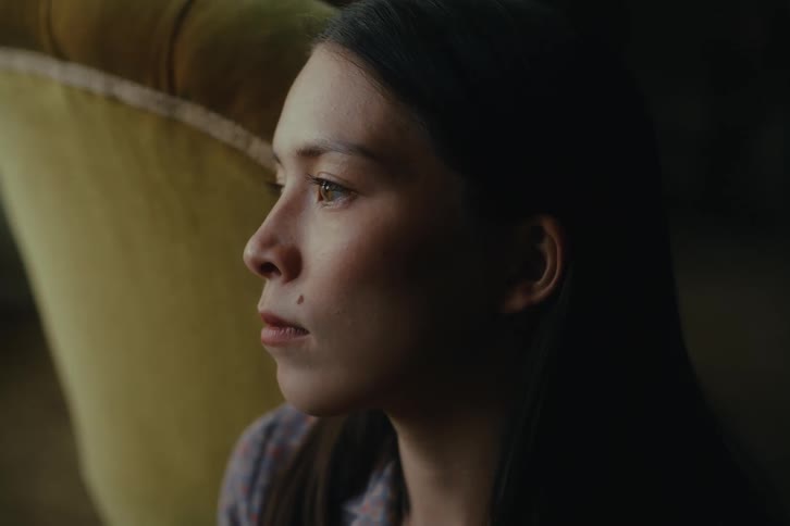 Portrait of a sitting woman running her hand through her hair