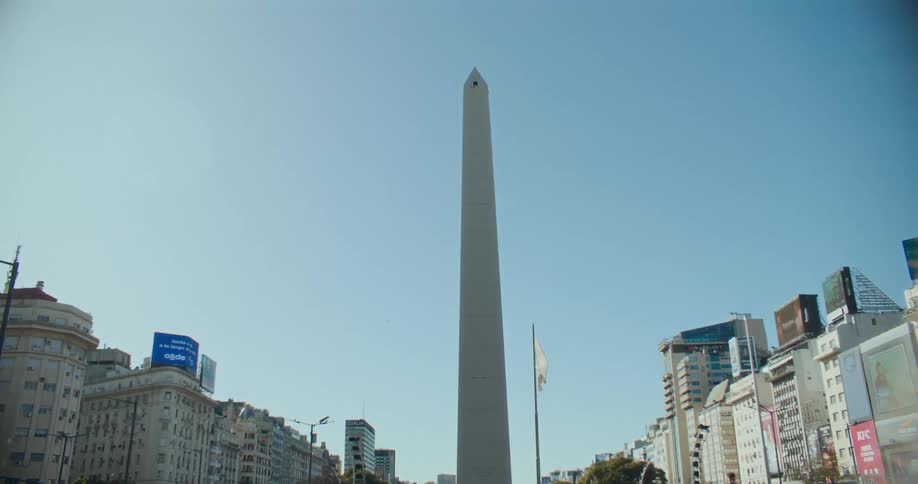 A tall slim tower is at the center of the city