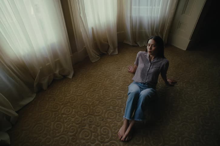Woman sitting in a room on a rug