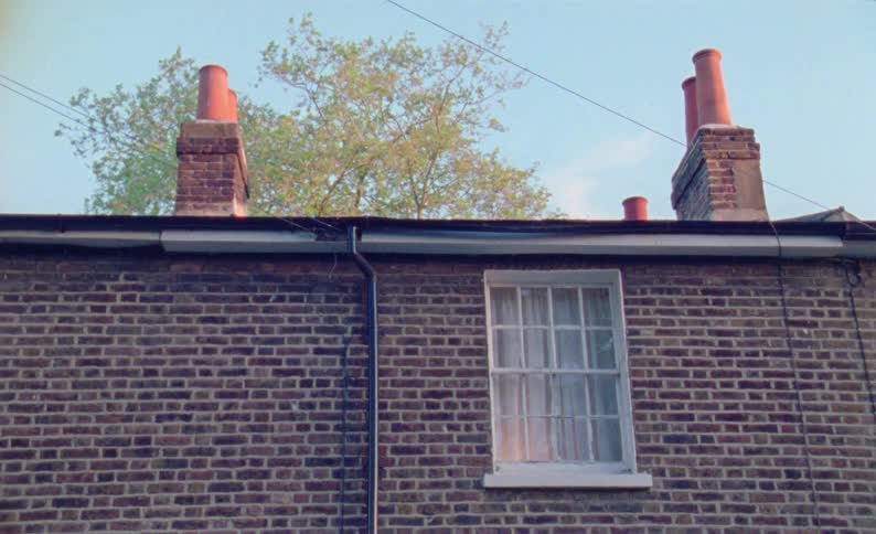 A window on a red brick wall