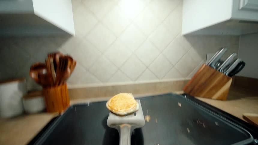Point of view of a spatula throwing a fried egg