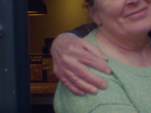A woman is hugging a person and she is squeezing the persons belly