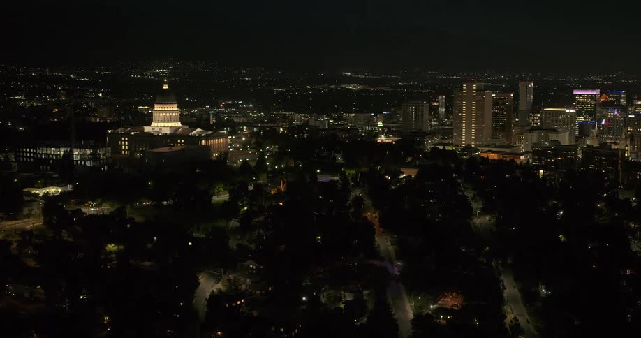 Towers and a domed building light up a city